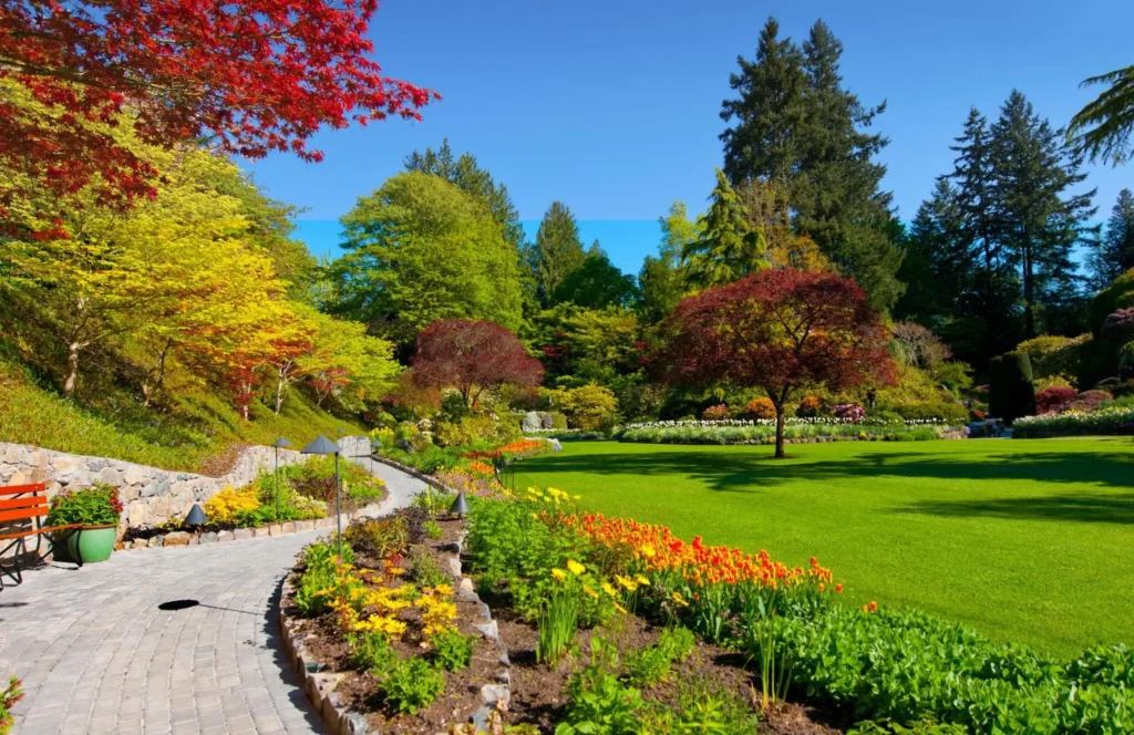 Spring garden with lush green lawn, Butchart Gardens, Victoria, Canada.