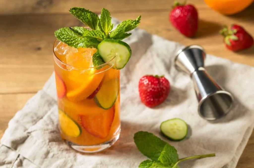 Refreshing Boozy PImms Cup Cocktail with Gin Strawberries and Cucumber
