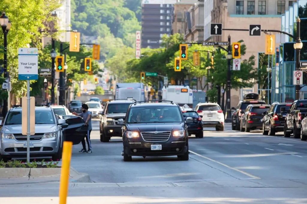 Cars driving across the intersection of James Street North and King Street West downtown Hamilton.