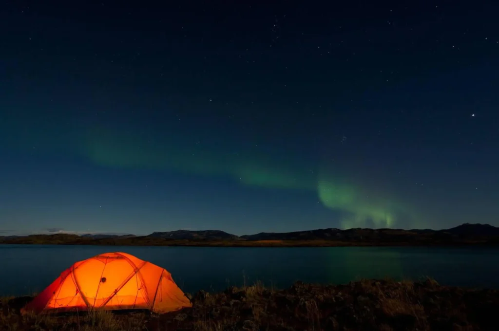 Illuminated expedition tent, Northern lights, Polar Aurora Lake Laberge, near Whitehorse