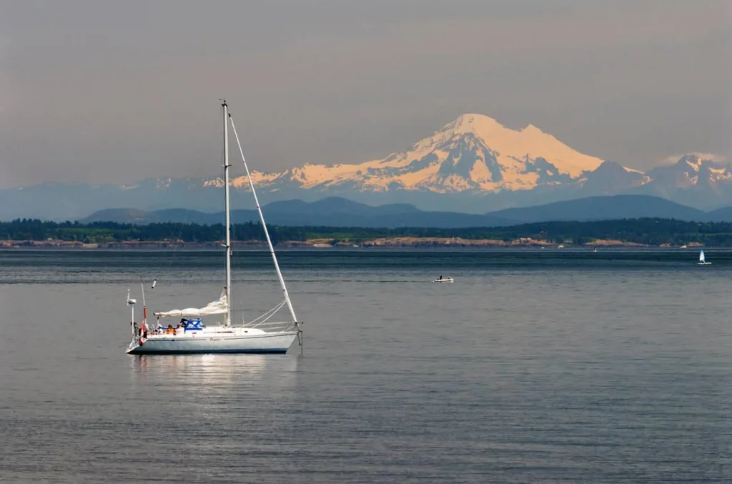 A sailboat off Willows Beach in Oak Bay in Victoria, British Columbia