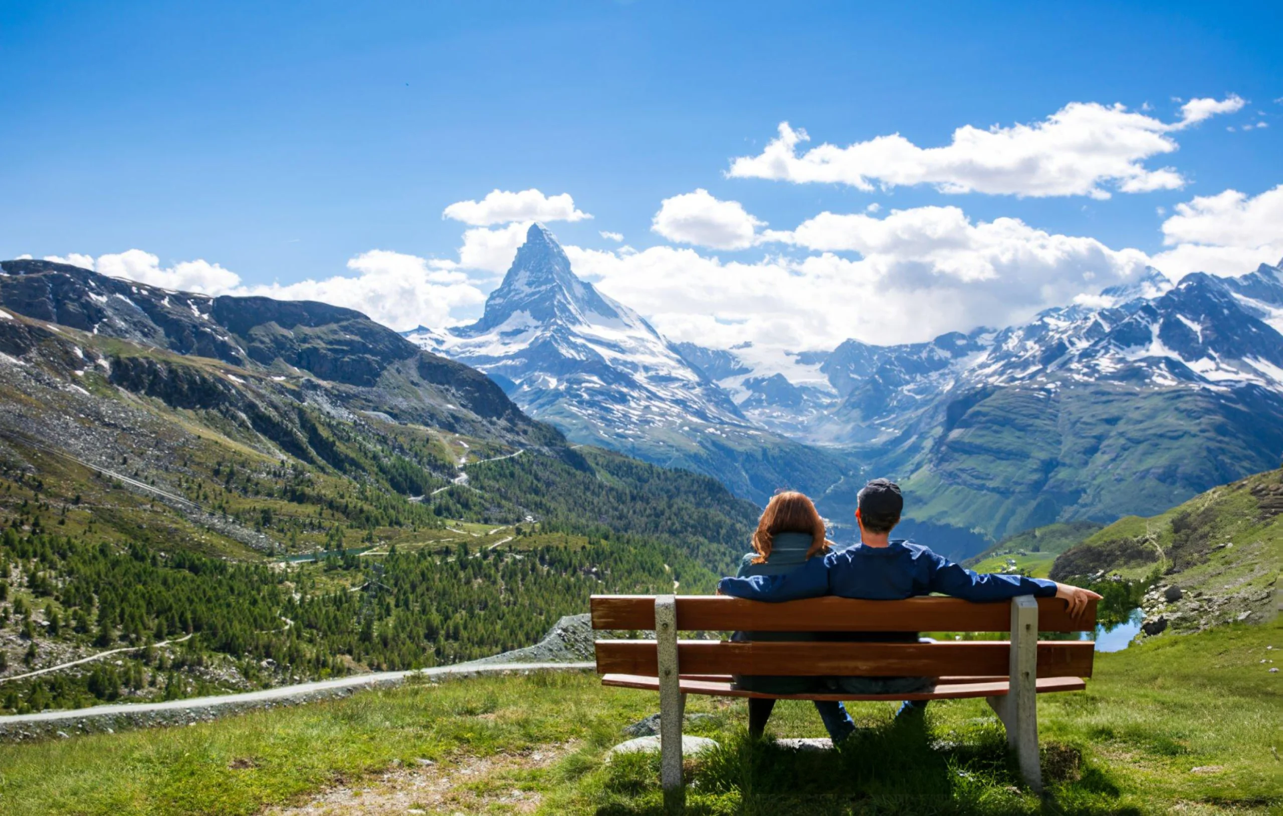 Couple on a bench taking in the view of the Matterhorn, Zermatt Switzerland